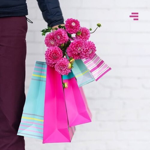 Mão segurando sacolas com rosas, ilustrando o blogpost Pare de agradar seus clientes.